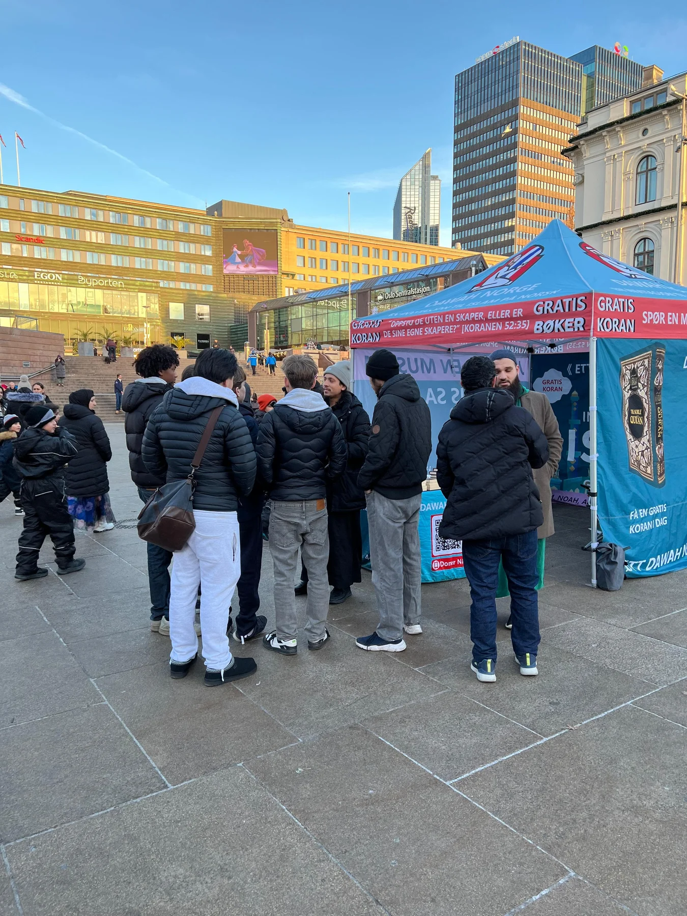 A group gathered at the Dawah Norway tent outside Oslo Central Station